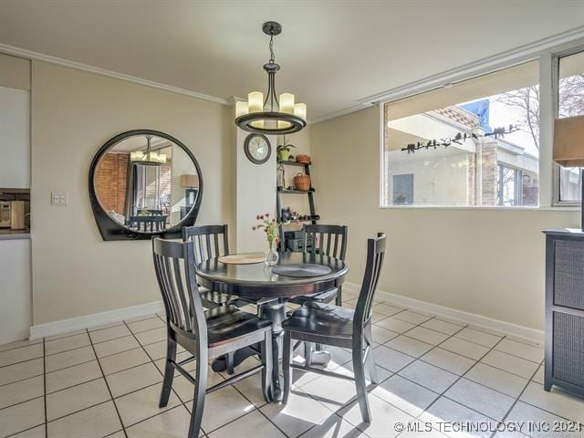 dining area featuring a notable chandelier, light tile patterned flooring, and crown molding