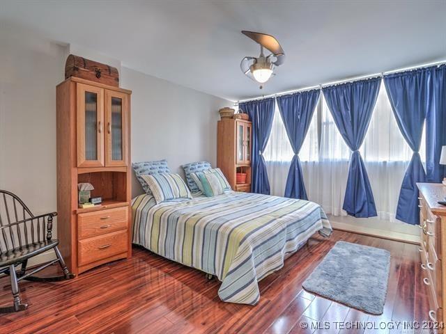 bedroom with dark wood-type flooring