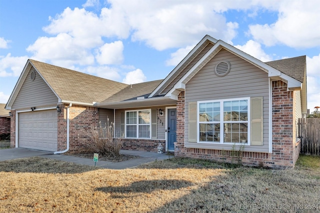 view of front of house featuring a garage and a front yard