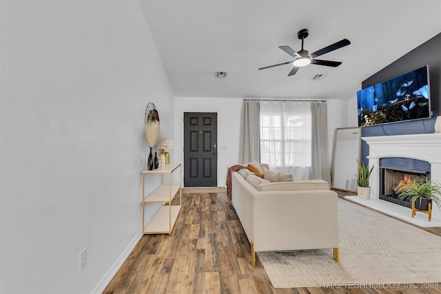 living room featuring ceiling fan, lofted ceiling, and hardwood / wood-style flooring