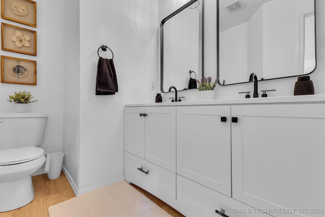 bathroom featuring vanity, toilet, and wood-type flooring