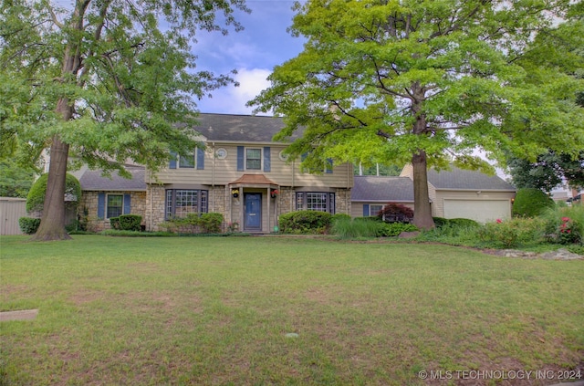 view of front facade with a garage and a front lawn