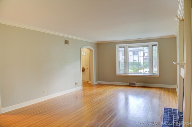 spare room featuring light hardwood / wood-style flooring and ornamental molding