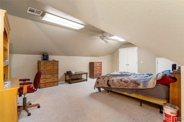 carpeted bedroom with ceiling fan, lofted ceiling, and a textured ceiling