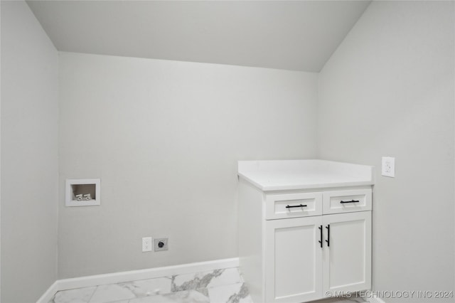 laundry area with hookup for an electric dryer, washer hookup, and cabinets