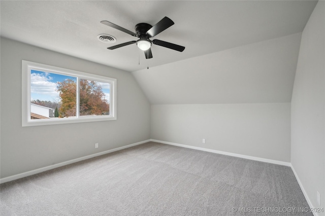 additional living space with ceiling fan, carpet floors, and vaulted ceiling