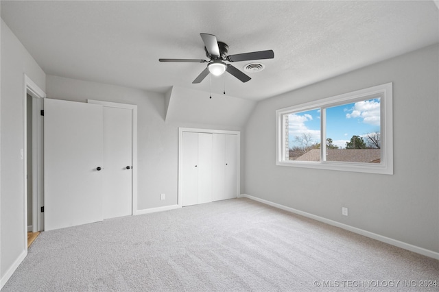 unfurnished bedroom with carpet, ceiling fan, and lofted ceiling