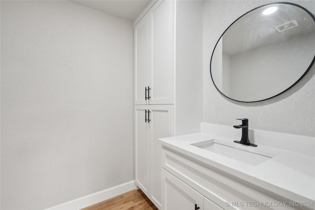 bathroom with vanity and hardwood / wood-style flooring