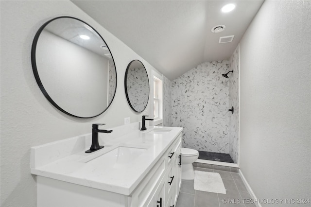 bathroom featuring tile patterned floors, vanity, vaulted ceiling, a shower, and toilet