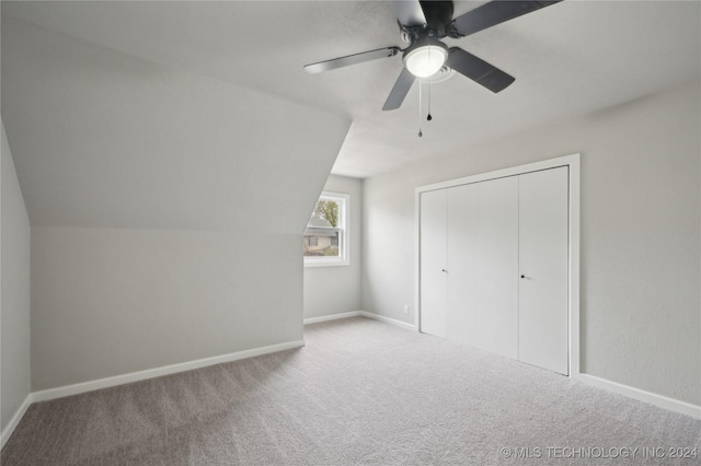 additional living space with ceiling fan, carpet floors, and lofted ceiling