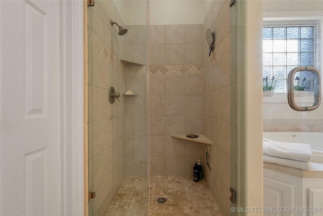 bathroom with shower with separate bathtub