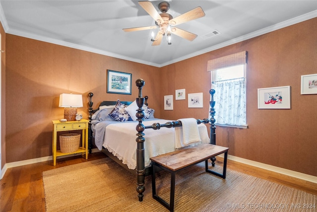 bedroom with ceiling fan, wood-type flooring, and crown molding