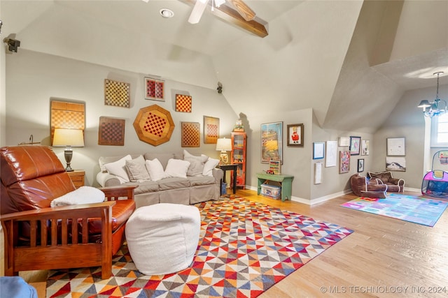 living room featuring a chandelier, light hardwood / wood-style floors, and vaulted ceiling