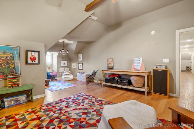 rec room featuring a chandelier, wood-type flooring, and vaulted ceiling with beams