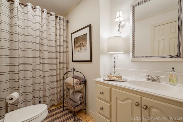 bathroom with tile patterned flooring, vanity, toilet, and ornamental molding