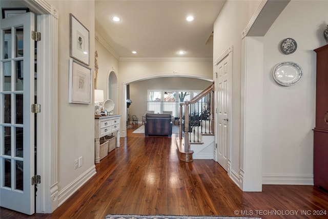 hallway with dark hardwood / wood-style flooring and crown molding