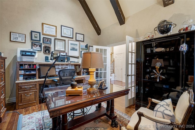 home office with beamed ceiling, hardwood / wood-style floors, and high vaulted ceiling