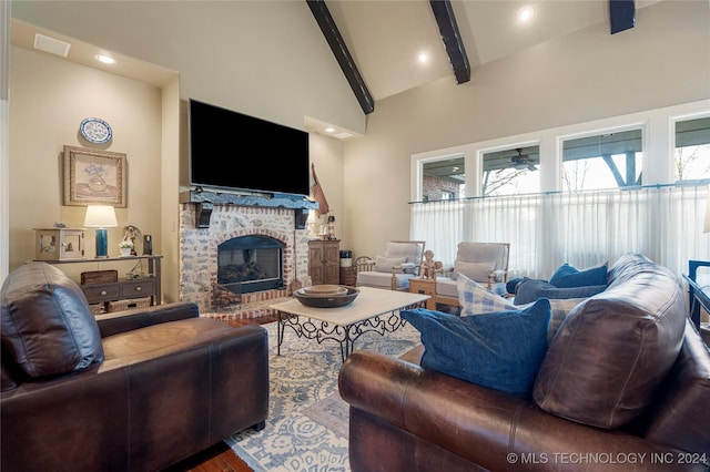 living room featuring beamed ceiling, hardwood / wood-style flooring, a fireplace, and high vaulted ceiling