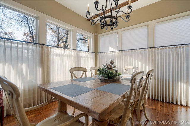 dining room featuring hardwood / wood-style floors and a chandelier