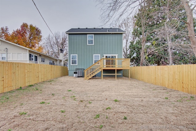 rear view of property featuring central AC unit and a deck