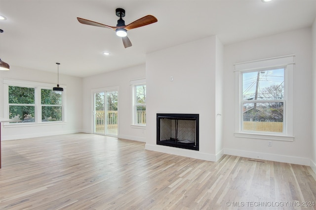 unfurnished living room with ceiling fan and light hardwood / wood-style floors