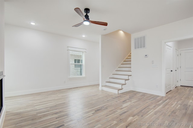 unfurnished living room with light wood-type flooring and ceiling fan