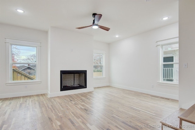 unfurnished living room with ceiling fan and light wood-type flooring