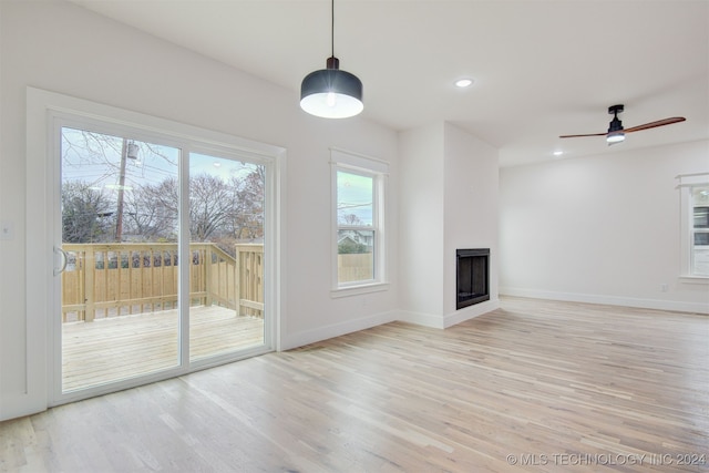 unfurnished living room featuring light wood-type flooring and ceiling fan