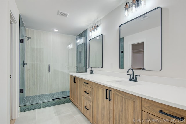 bathroom with tile patterned floors, vanity, and walk in shower