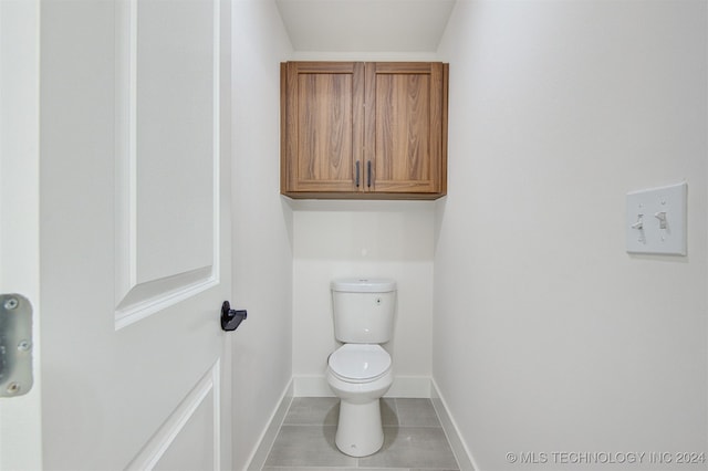 bathroom featuring tile patterned floors and toilet