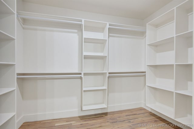 spacious closet with hardwood / wood-style floors