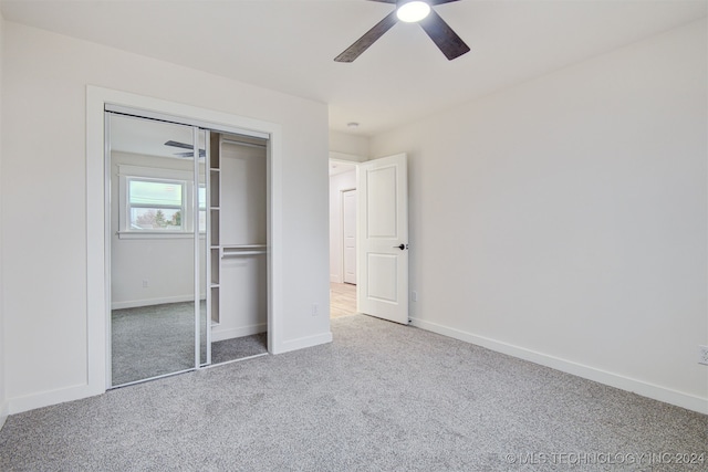 unfurnished bedroom with ceiling fan, carpet floors, and a closet