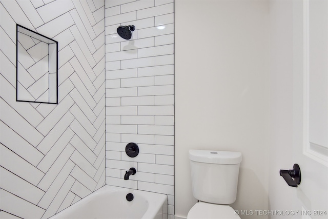 bathroom featuring toilet and tiled shower / bath