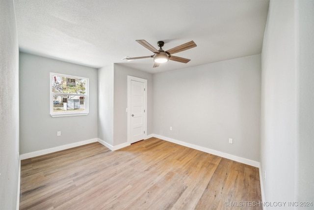 unfurnished bedroom with ceiling fan, light hardwood / wood-style flooring, and a textured ceiling