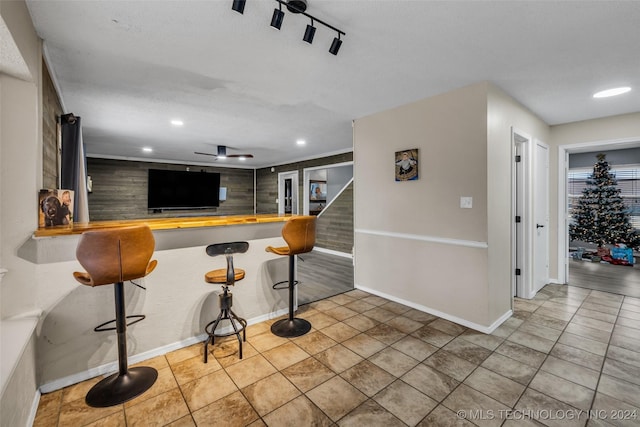 interior space featuring light tile patterned flooring and ceiling fan