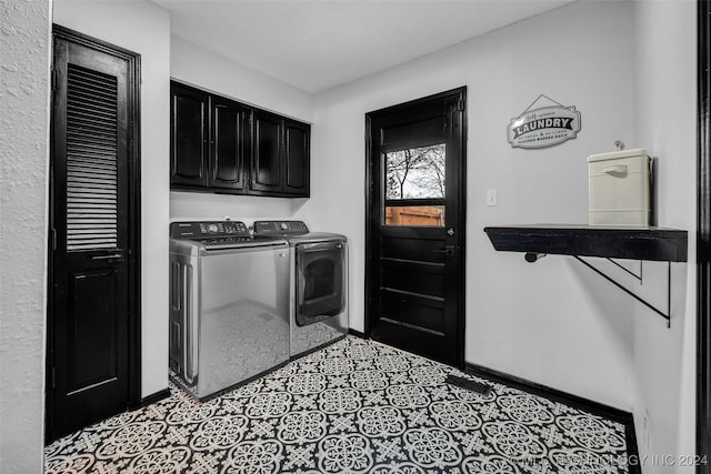 clothes washing area featuring washer and clothes dryer, light tile patterned flooring, cabinet space, and baseboards