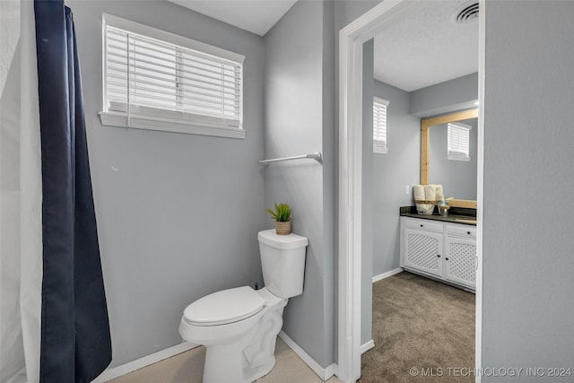 bathroom with visible vents, toilet, and baseboards