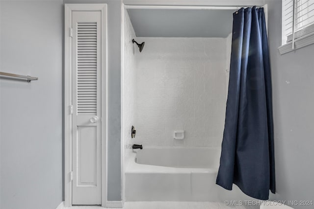 bathroom featuring shower / bath combo and a closet