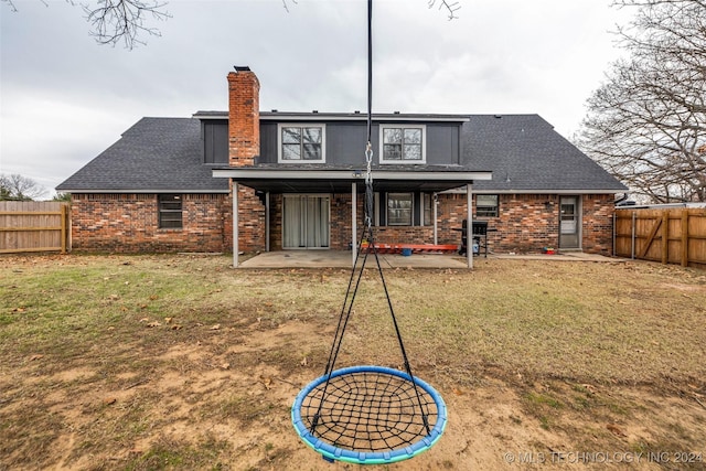 rear view of property featuring fence private yard, brick siding, a patio, and a chimney