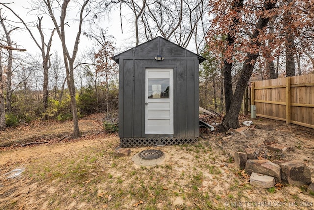 view of shed with fence