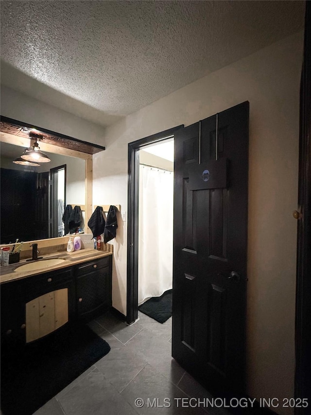 bathroom with vanity and a textured ceiling