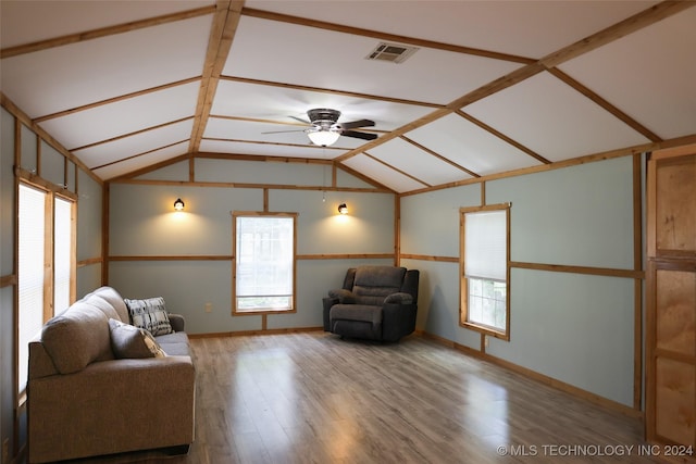 unfurnished room with a ceiling fan, lofted ceiling, visible vents, and wood finished floors