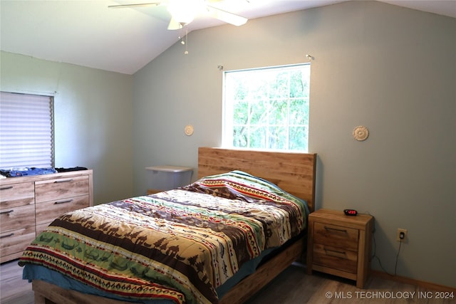 bedroom featuring lofted ceiling, wood finished floors, and a ceiling fan