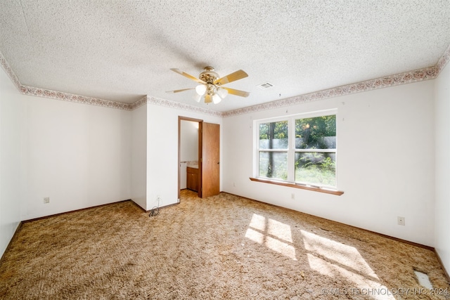 unfurnished bedroom with ceiling fan, carpet, and a textured ceiling