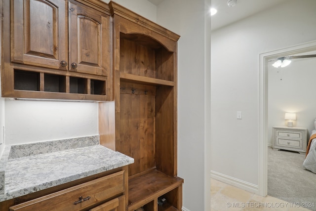 mudroom with ceiling fan and light colored carpet