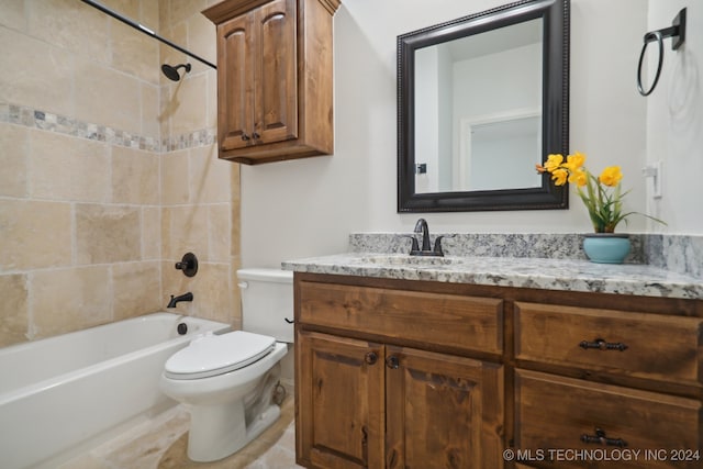 full bathroom featuring vanity, toilet, and tiled shower / bath