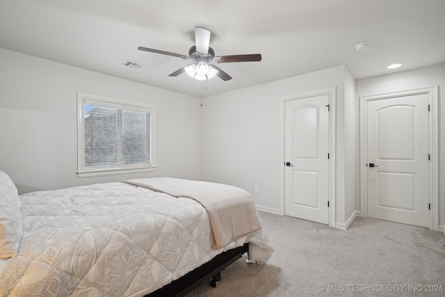 bedroom with ceiling fan and light carpet