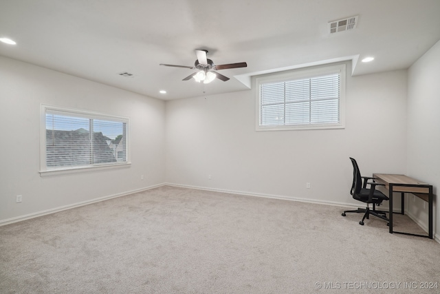 office area featuring light carpet and ceiling fan