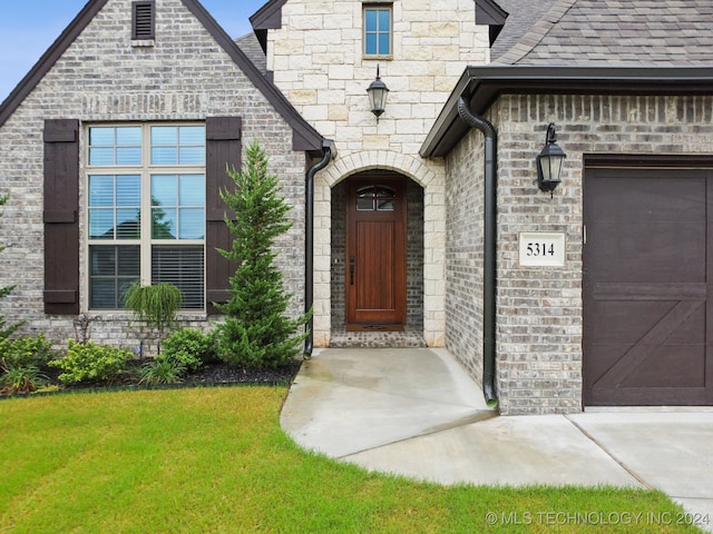 doorway to property with a garage