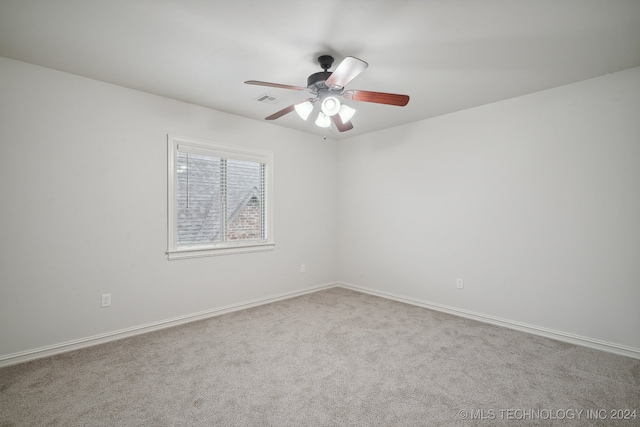 spare room featuring ceiling fan and light colored carpet